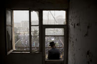 <p>An Ultra-Orthodox Jewish man watches from a balcony as hundreds of thousands of Ultra-Orthodox Jews rally in a massive show of force against plans to force them to serve in the Israeli military, blocking roads and paralyzing the city of Jerusalem, March 2, 2014. (Photo: Oded Balilty/AP) </p>