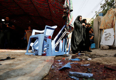 People gather at the site of a suicide bomb attack in the city's northern al-Shaab district in Baghdad, Iraq October 15, 2016. REUTERS/Ahmed Saad