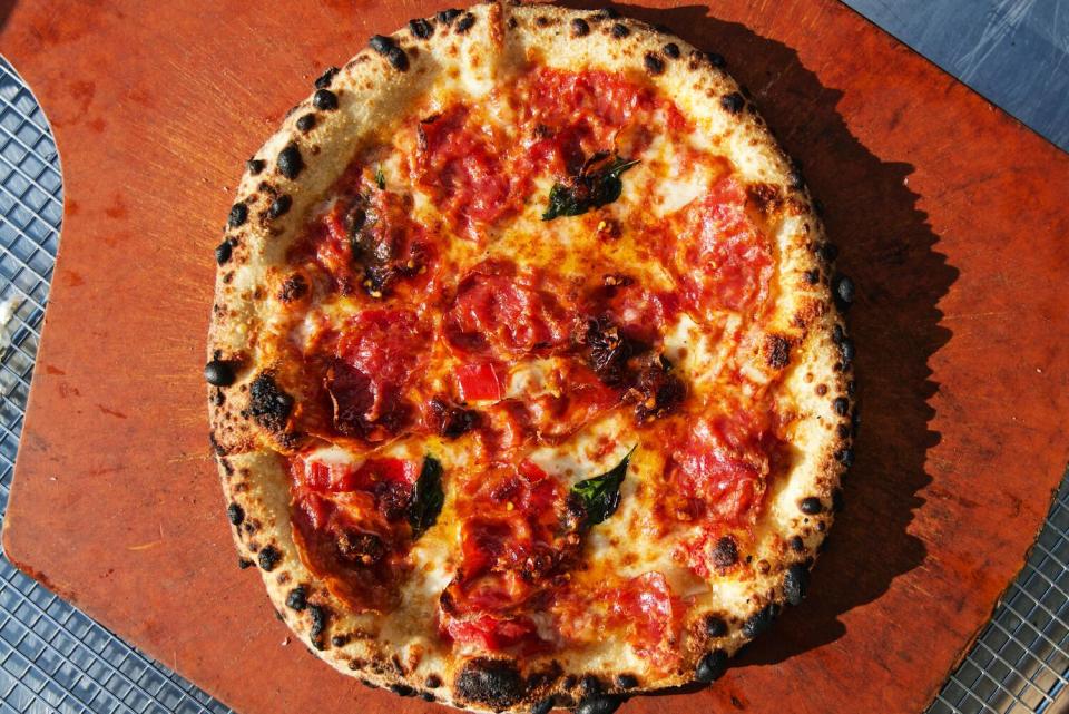 An overhead photo of a pizza with a blistered crust.