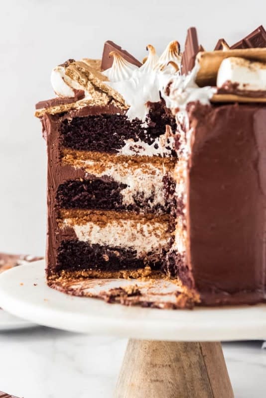 <p>House of Nash Eats</p><p>This S'mores cake is an over-the-top decadent dessert with layers of moist chocolate cake, graham cracker crust, chocolate ganache and homemade marshmallow filling, all surrounded by a luscious buttercream frosting. It's a scrumptious, irresistible twist on one of summer's most iconic desserts!</p><p><strong>Get the recipe: <a href="https://houseofnasheats.com/smores-cake/" rel="nofollow noopener" target="_blank" data-ylk="slk:3-Layer S'mores Cake;elm:context_link;itc:0;sec:content-canvas" class="link ">3-Layer S'mores Cake</a></strong></p>