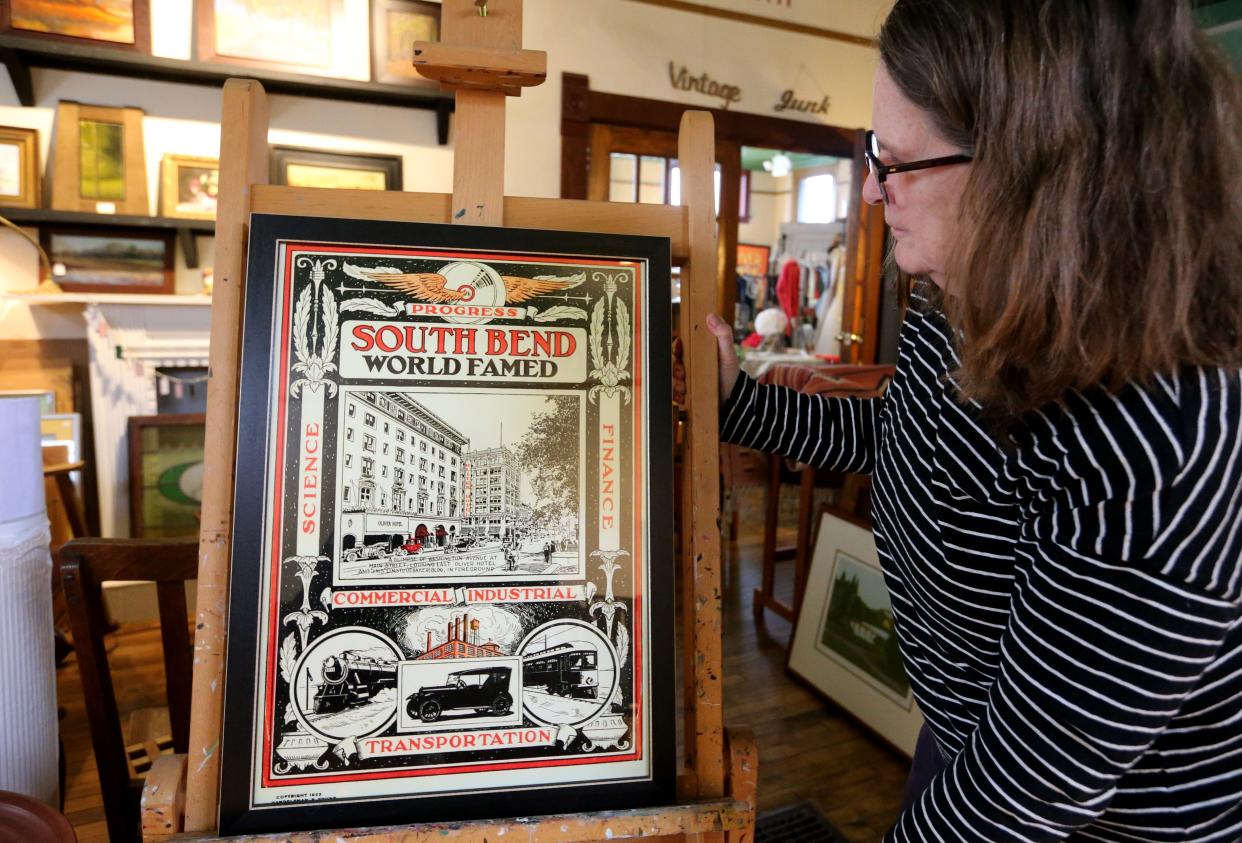 Circa Arts owner Kathy Reddy White looks at the 1922 "Progress-South Bend-World Famed"  poster that's for sale at her South Bend gallery.