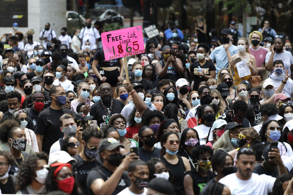 People demonstrate in Chicago, Friday, June 19, 2020, to mark Juneteenth, the holiday celebrating the day in 1865 that enslaved black people in Galveston, Texas, learned they had been freed from bondage, more than two years after the Emancipation Proclamation. (AP Photo/Nam Y. Huh)
