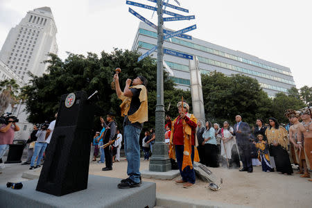 The inaugural "Indigenous People's Day" begins with a sunrise celebration as Chief Anthony "Red Blood" Morales (C) and his son Andrew "Guiding Young Cloud" Morales sing in downtown Los Angeles, California, U.S., October 8, 2018. REUTERS/Mike Blake