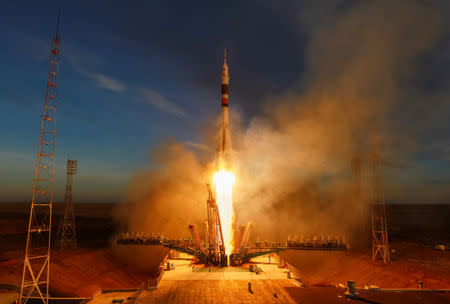 FILE PHOTO: The Soyuz MS-11 spacecraft carrying the crew formed of David Saint-Jacques of Canada, Oleg Kononenko of Russia and Anne McClain of the U.S. blasts off to the International Space Station (ISS) from the launchpad at the Baikonur Cosmodrome, Kazakhstan December 3, 2018. REUTERS/Shamil Zhumatov