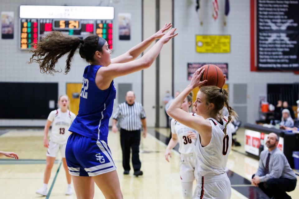 Spring Grove's Leah Kale (22) attempts to block South Western's Oliva Sell (0) during the first half of a girls basketball game between the South Western Mustangs and the Spring Grove Rockets, Friday, Jan. 21, 2022, at South Western High School in Penn Township.