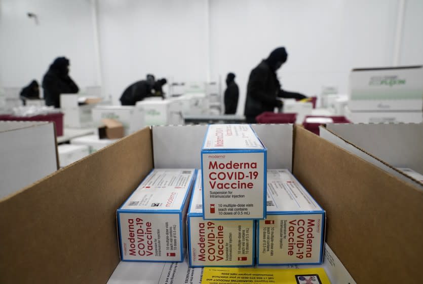 Boxes containing the Moderna COVID-19 vaccine are prepared to be shipped at the McKesson distribution center in Olive Branch, Miss., Sunday, Dec. 20, 2020. (AP Photo/Paul Sancya, Pool)