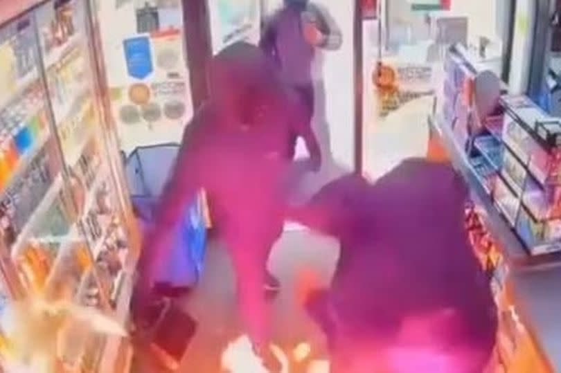 The moment when gasoline is poured on the floor of the store and set on fire