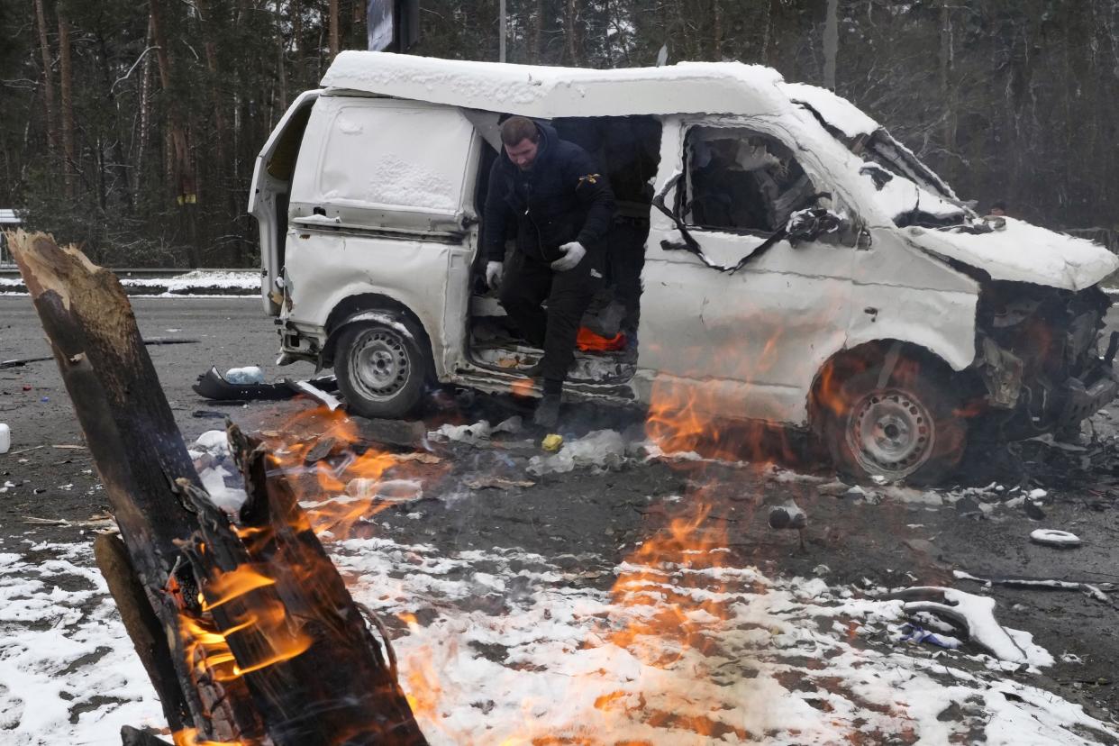 A man leaves a vehicle damaged by shelling in Brovary, outside Kyiv, Ukraine, Tuesday, March 1, 2022.