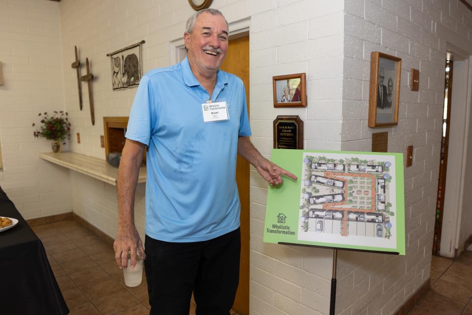Bryan Benz, founder of Wholistic Transformation, points out drawings that map out the future tiny home village for youth aging out of the foster care system on Aug. 31, 2023.