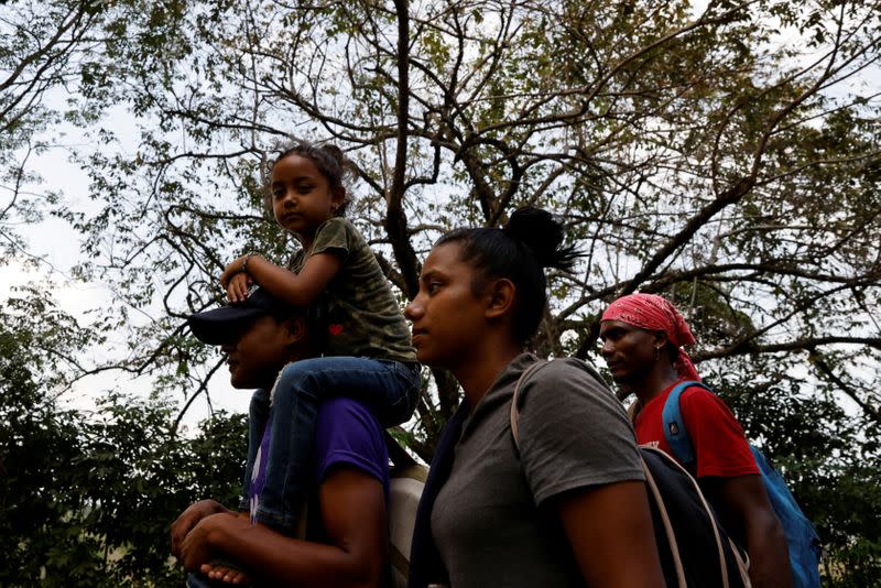 FILE PHOTO: Arony Maude from Honduras is carried by her uncle along a motorway in El Ceibo while making their way to the U.S.