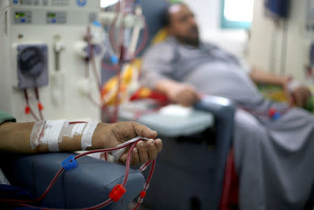 A Palestinian patient sleeps as he undergoes kidney dialysis at Shifa hospital in Gaza City. REUTERS/Mohammed Salem