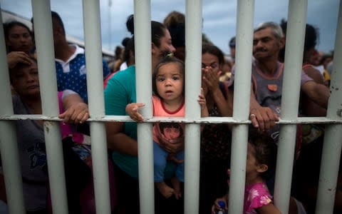 Around 200 were taken to a detention centre - thousands more remain on the bridge - Credit: AP