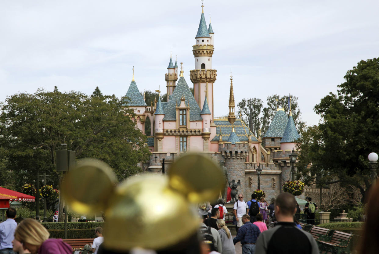 FILE - Visitors walk toward Sleeping Beauty's Castle in the background at Disneyland Resort on Jan. 22, 2015, in Anaheim, Calif. Disney CEO Bob Iger on Monday, April 3, 2023, called efforts by Florida Gov. Ron DeSantis and the Republican-controlled Florida Legislature to retaliate against the company for its policy positions as not only “anti-business but anti-Florida.” (AP Photo/Jae C. Hong, File)