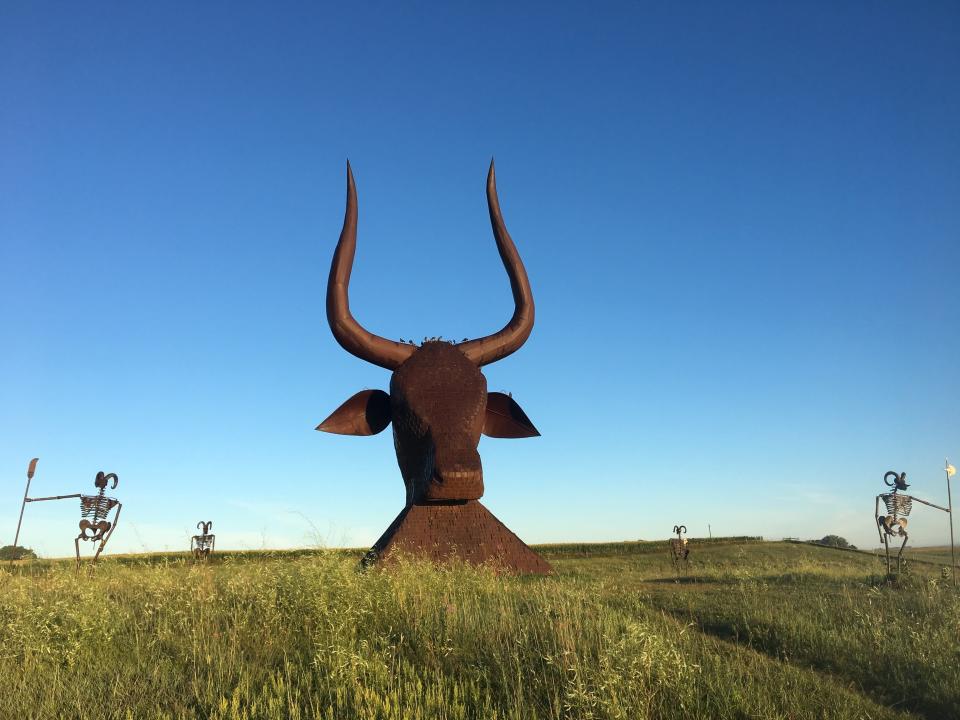 The bull is surrounded by the guardians' figures.