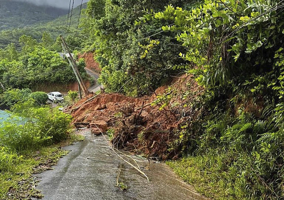 The aftermath of a massive explosion at an industrial area on the main island in Mahe, Seychelles, Thursday, Dec. 7, 2023. Authorities in Seychelles declared a state of emergency Thursday after a blast at an explosives store caused “massive damage” in an industrial area also facing flooding amid heavy rainfall, according to the presidency. The blast happened on Wednesday night in the Providence area of Mahe, the largest and most populous island of the Seychelles. (AP Photo/Emilie Chetty)