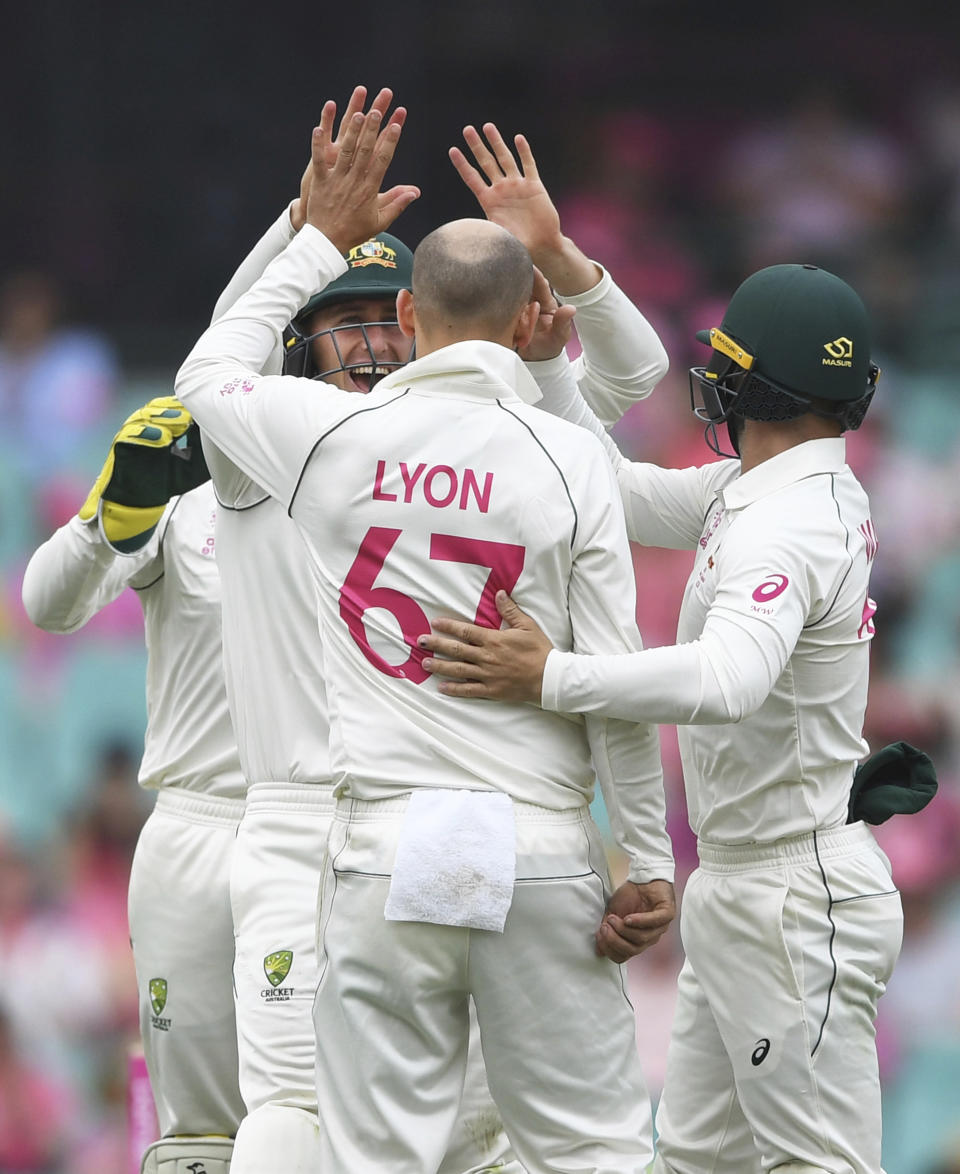 Australia's Nathan Lyon (67) is celebrated by teammates after bowling New Zealand's Tom Blundell on day three of the third cricket test match between Australia and New Zealand at the Sydney Cricket Ground in Sydney Sunday, Jan. 5 2020. (Andrew Cornaga/Photosport via AP )