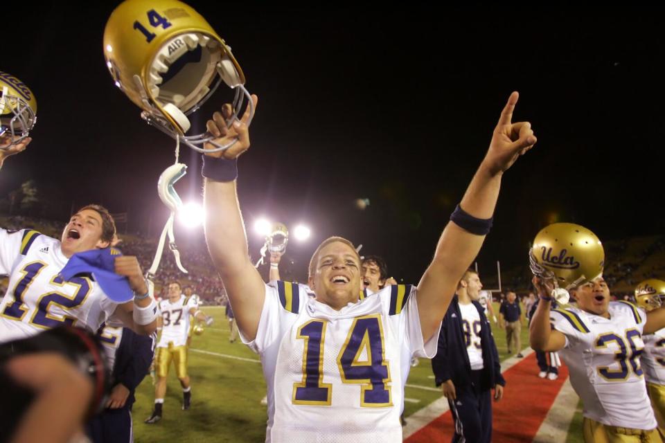 UCLA quarterback Drew Olson (14) celebrates a 30-27 overtime win over Stanford on Saturday.