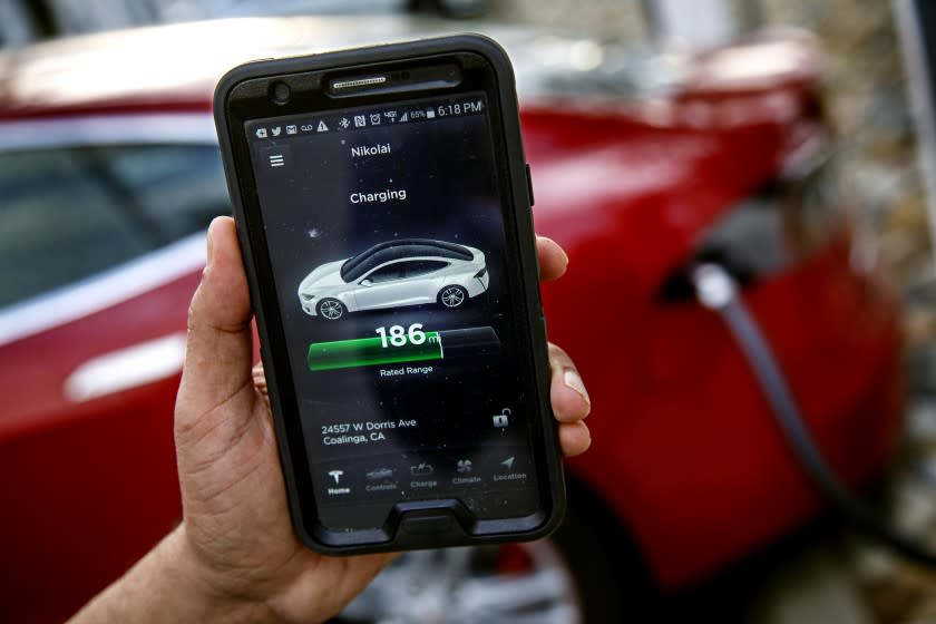 COALINGA - CA - MARCH 10, 2015 - One can use a smart phone to monitor the progress of a Tesla being charged at the station in front of Harris Farm Restaurant in Coalinga, off Interstate 5, March 10, 2015. (Ricardo DeAratanha/Los Angeles Times)