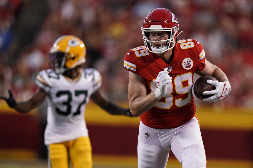 Kansas City Chiefs tight end Matt Bushman (89) scores on a touchdown run as Green Bay Packers cornerback Rico Gafford (37) gives chase during the first half of an NFL preseason football game Thursday, Aug. 25, 2022, in Kansas City, Mo. (AP Photo/Charlie Riedel)