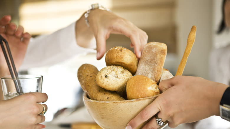 People passing bread basket