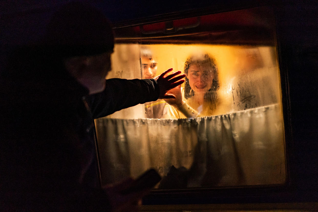 George Keburia says goodbye to his wife Maya and children as they board a train to Lviv at the Odessa train station in Odessa, Ukraine, on March 5.