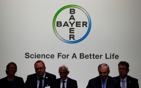 FILE PHOTO: Members of the supervisory board of German pharmaceutical and chemical maker Bayer AG are silhouetted against the company's logo at the annual general shareholders meeting in Bonn, Germany, April 28, 2017. REUTERS/Wolfgang Rattay