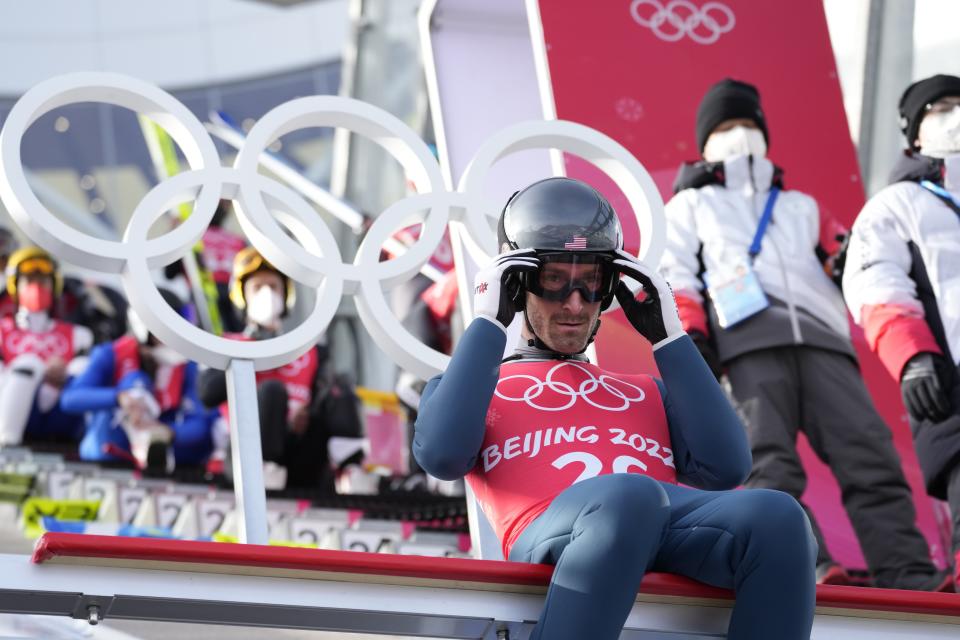 Taylor Fletcher, of the United States, adjusts his goggles during a ski jumping training session in the Gundersen normal hill Nordic Combined event at the 2022 Winter Olympics, Monday, Feb. 7, 2022, in Zhangjiakou, China. (AP Photo/Andrew Medichini)