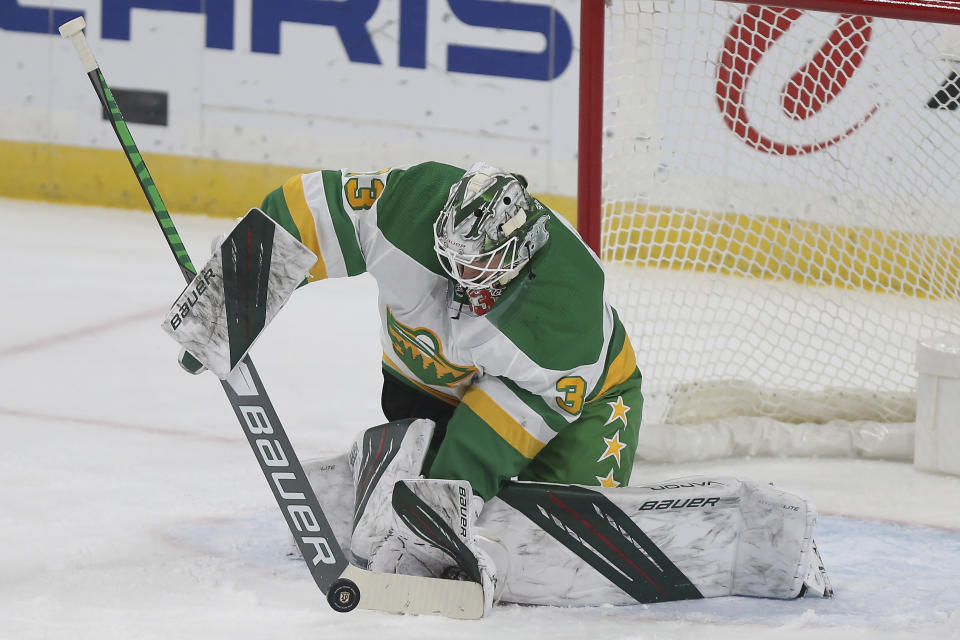 Minnesota Wild's goalie Cam Talbot (33) stops the puck in the first period of an NHL hockey game against the Colorado Avalanche, Sunday, Jan. 31, 2021, in St. Paul, Minn. (AP Photo/Stacy Bengs)