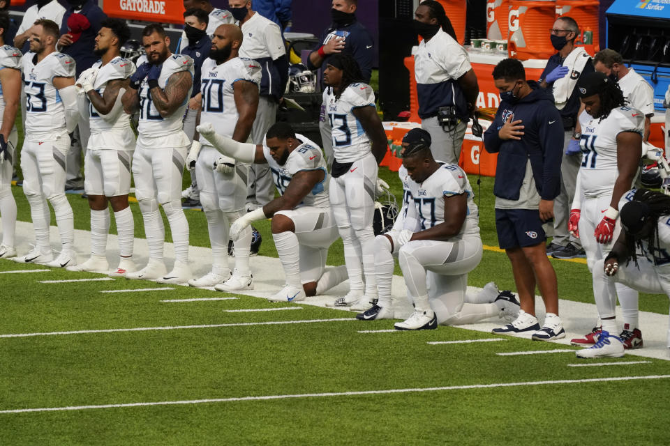 FILE - In this Sept. 27, 2020, file photo, members of the Tennessee Titans take part in the national anthem before an NFL football game against the Minnesota Vikings, in Minneapolis. Tennessee will not be returning to the team's facility Wednesday, Oct. 7, 2020, after two more players tested positive in the NFL's first COVID-19 outbreak, a person familiar with the situation told The Associated Press. The Titans had no positive tests Monday or Tuesday for the first time after six consecutive days of positive results. A third straight day was necessary for the team to be allowed back in its headquarters.(AP Photo/Jim Mone)