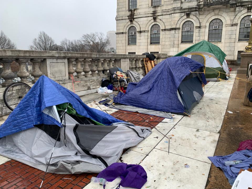Tents being removed from the terrace on the State House's north entrance plaza after homeless residents of an encampment there were served eviction notices Wednesday.