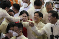 FILE - Philippine President Ferdinand Marcos Jr., center right, is greeted after his first state of the nation address in Quezon city, Philippines on July 25, 2022. Marcos Jr. has reaffirmed ties with the United States, the first major power he visited since taking office in June, in a key turnaround from the often-hostile demeanor his predecessor displayed toward Manila's treaty ally. (AP Photo/Aaron Favila, Pool, File)