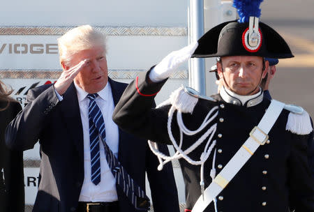 U.S. President Donald Trump salutes as he arrives at the Leonardo da Vinci-Fiumicino Airport in Rome, Italy, May 23, 2017. REUTERS/Remo Casilli