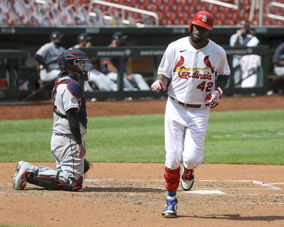 Cleveland Indians catcher Roberto Perez, left, looks on as St. Louis Cardinals' Dexter Fowler scores on a solo home run during the seventh inning of a baseball game Sunday, Aug. 30, 2020, in St. Louis. (AP Photo/Scott Kane)