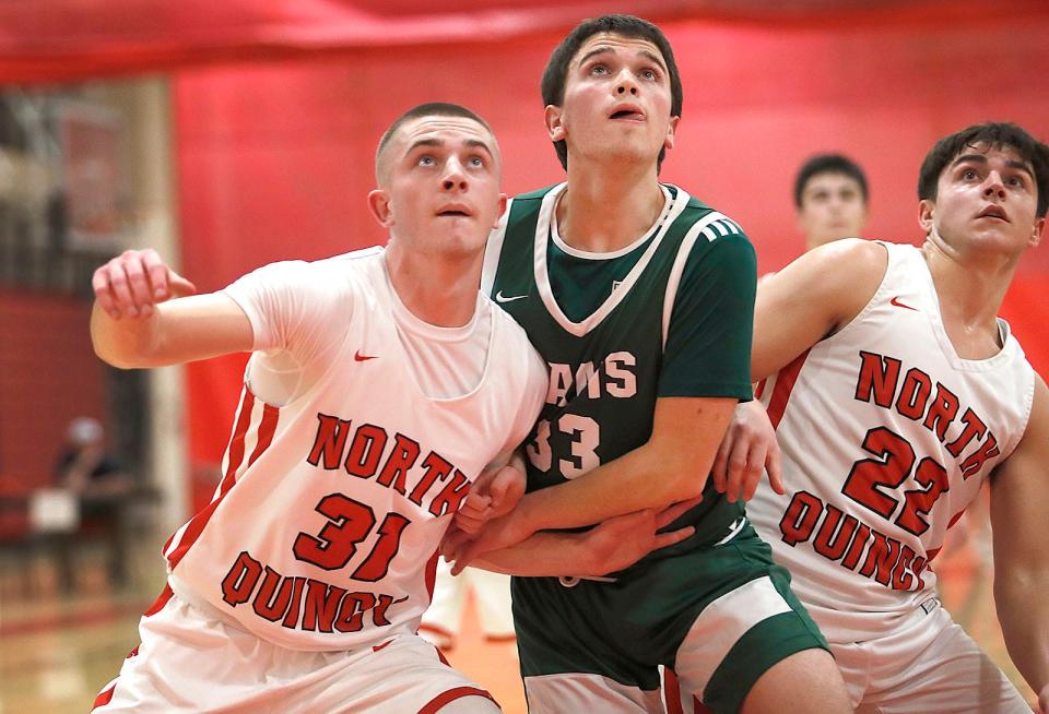 NQ Zach Taylor, Rams Ryan Treacy and NQ Nate Caldwell jockey for position to get a free throw rebound.North Quincy boys basketball hosted Marshfield and handed them their first loss of the season by a thirty point margin on Friday January 13, 2023.