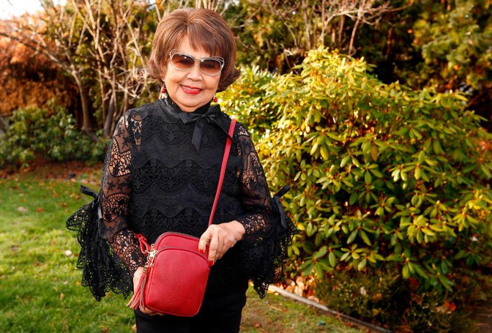 Josie Wannarachue, a longtime Tri-Cities businesswoman and civic leader, shows the purse named in her honor by her daughter, JoAnne Wannarachue Lord, the founder of a handbag company. Bob Brawdy/Tri-City Herald file