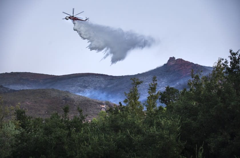 ANGELES NATIONAL FOREST, CA - SEPTEMBER 28, 2020: A water drop is made from a helicopter on the Martindale Fire burning above Bouquet Canyon Rd. In the Angeles National Forest, north of Santa Clarita. (Mel Melcon / Los Angeles Times)