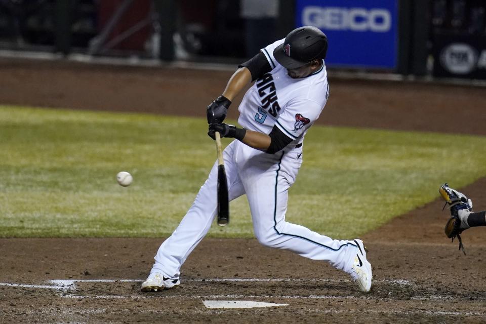 Arizona Diamondbacks' Eduardo Escobar connects for a single against the Texas Rangers during the fourth inning of a baseball game Tuesday, Sept. 22, 2020, in Phoenix. (AP Photo/Ross D. Franklin)