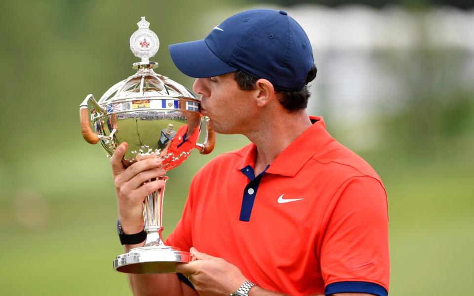 Rory McIlroy poses with the Canadian Open trophy - USA TODAY Sports