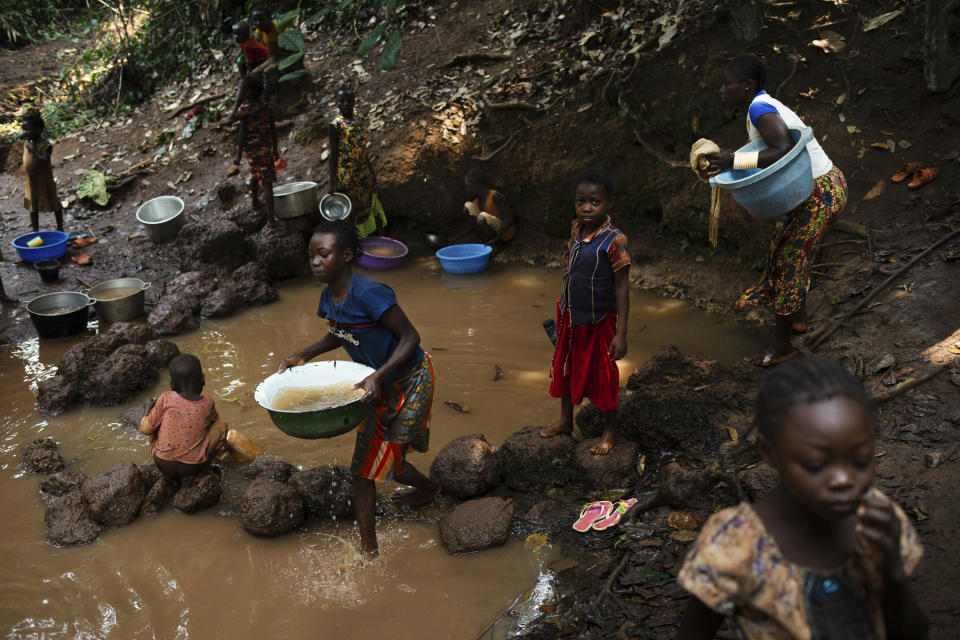 Displaced people who fled Bangassou use this water source to drink, cook and wash in the village of Siwa where they found refuge, in Central African Republic, Saturday Feb. 13, 2021. An estimated 240,000 people have been displaced in the country since mid-December, according to U.N. relief workers, when rebels calling themselves the Coalition of Patriots for Change launched attacks, causing a humanitarian crisis in the already unstable nation. (AP Photo/Adrienne Surprenant)