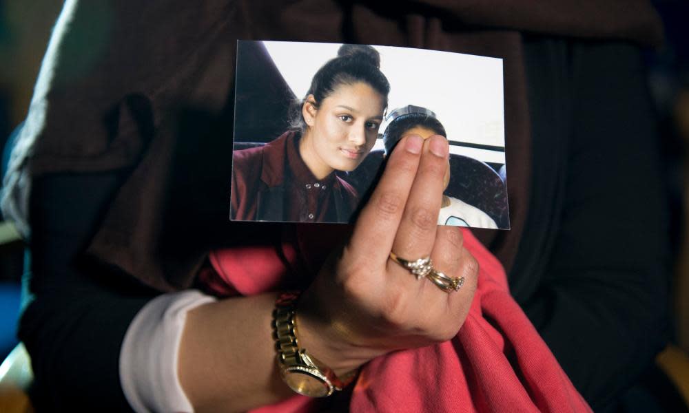 Renu, eldest sister of Shamima Begum, holds her sibling’s photo while being interviewed by the media.