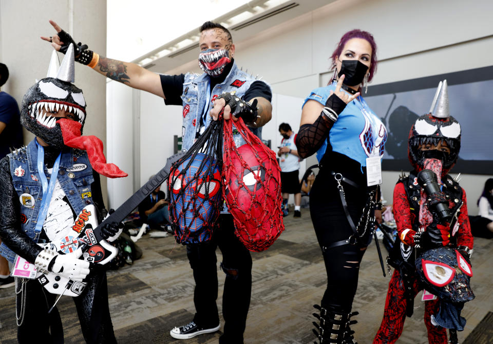 New Jersey residents Cristian Tirado, as Venom Punk, from left, Jose Tirado as Eddie Rock Punk, Letticia Tirado as Queen Punk and Gabriel Tirado as Carnage Punk, attend day one of Comic-Con International on Thursday, July 21, 2022, in San Diego. (Photo by Christy Radecic/Invision/AP)