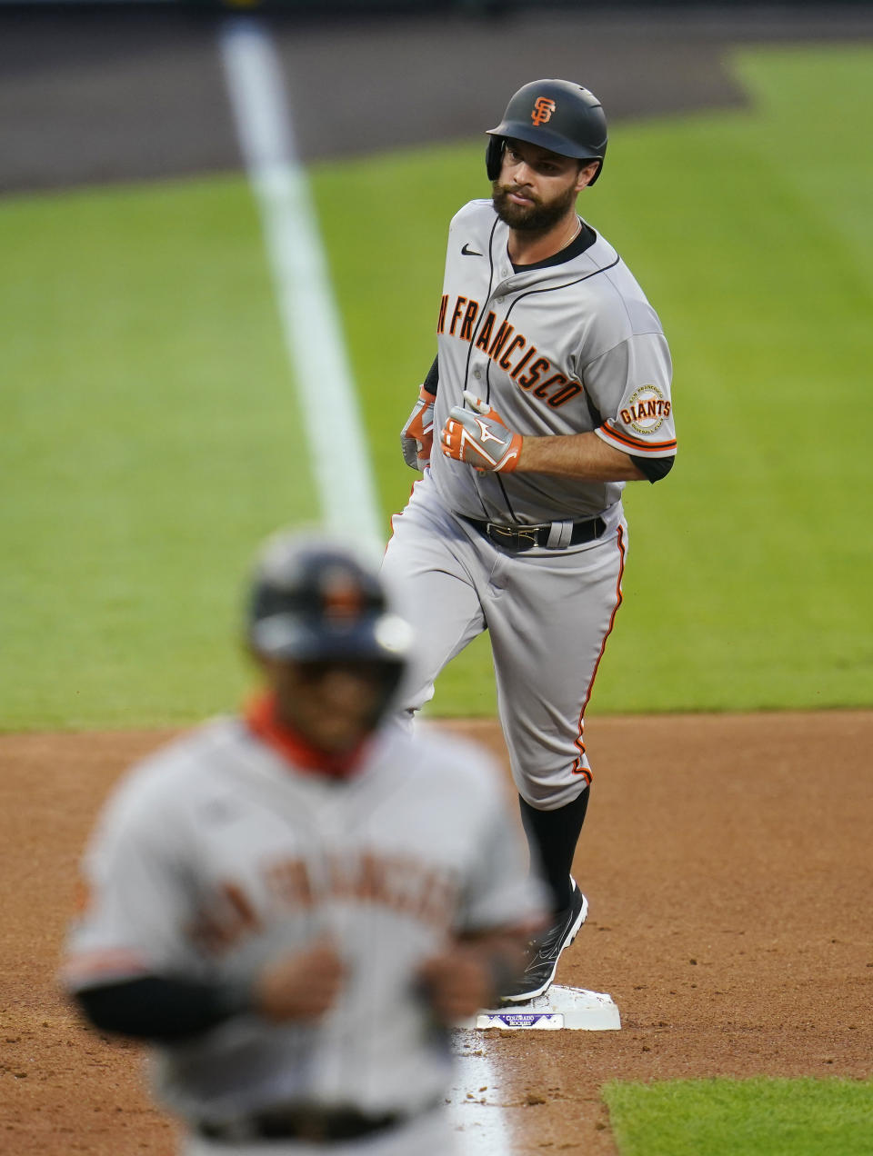 San Francisco Giants' Brandon Belt rounds the bases after hitting a three-run home run against the Colorado Rockies during the fourth inning of a baseball game, Wednesday, Aug. 5, 2020, in Denver. (AP Photo/Jack Dempsey)