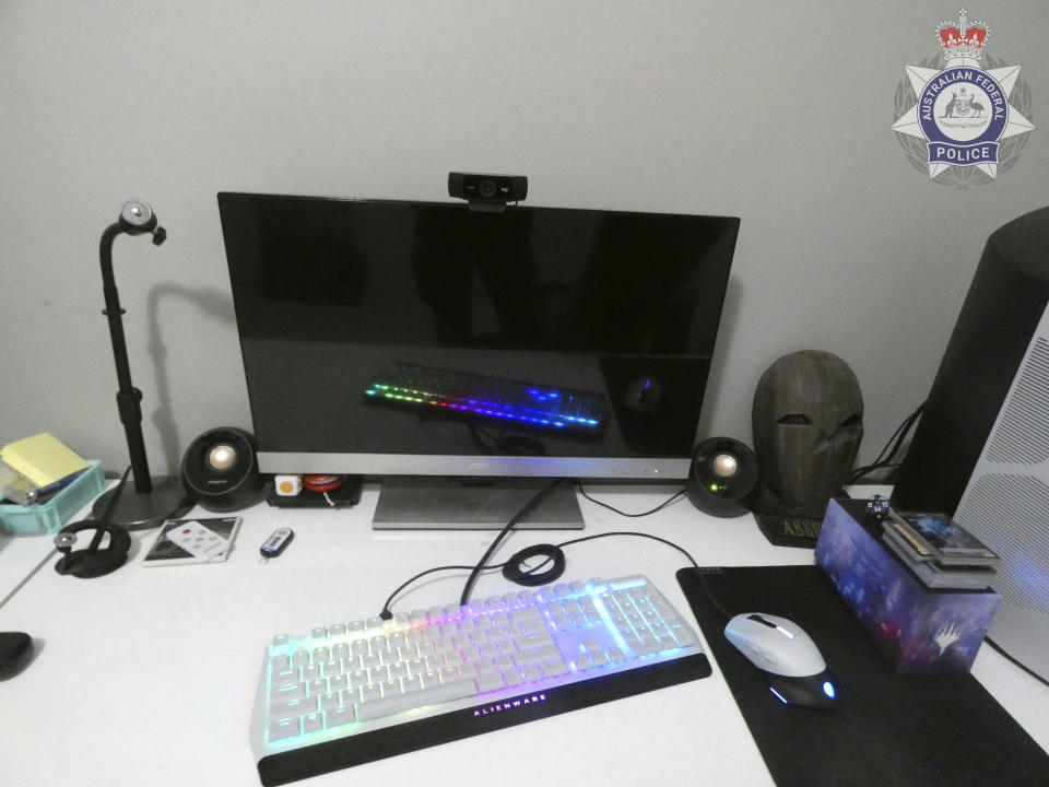 In this undated photo provided by the Australian Federal Police, a suspect's computer is displayed on a desk. Police have charged 19 men in Australia with child sex abuse offenses and rescued 13 children from further harm following tip offs from the U.S. Federal Bureau of Investigation officials said on Tuesday, Aug. 8, 2023. (Australian Federal Police via AP)