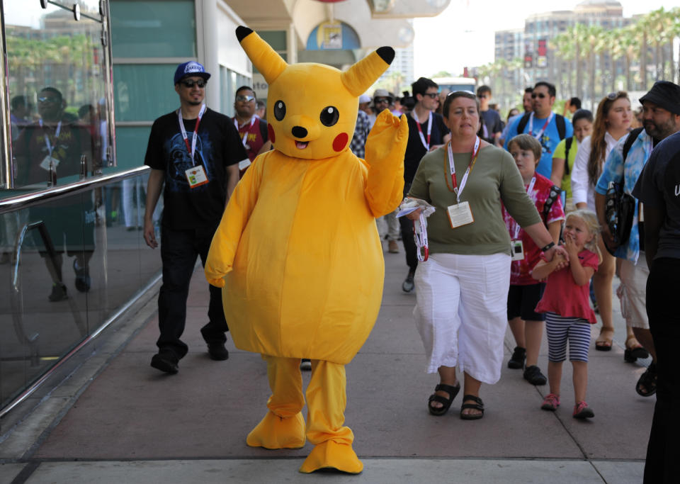 A fan dressed as Pokemon's Pikachu walks past the lines before Preview Night of Comic-Con International at the San Diego Convention Center Wednesday July 8, 2015, in San Diego. (Photo by Denis Poroy/Invision/AP)