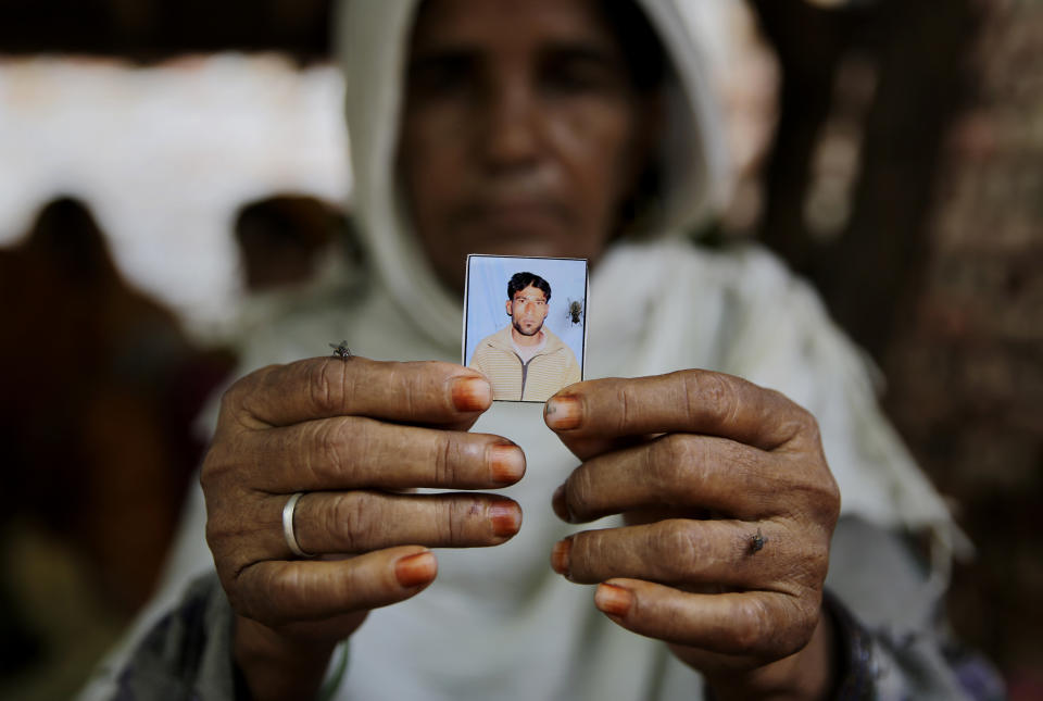 In this Tuesday, July 24, 2018, file photo, Kareeman Bano holds a photograph of her son-in-law Rakbar Khan, who died after being thrashed by a mob last week on suspicion of cattle smuggling, in Kolgaon village, India. In a February 2019 report, Human Rights Watch said that between May 2015 and December 2018, at least 36 Muslims were killed by gangs of cow vigilantes who suspected them of consuming beef or illegally moving cattle. Modi’s critics say that India’s Muslim minority, 14% of India’s 1.3 billion people, will continue to feel persecuted and insecure. (AP Photo/Altaf Qadri, File)