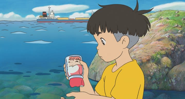 A kid holding Ponyo in a glass jar by the sea.