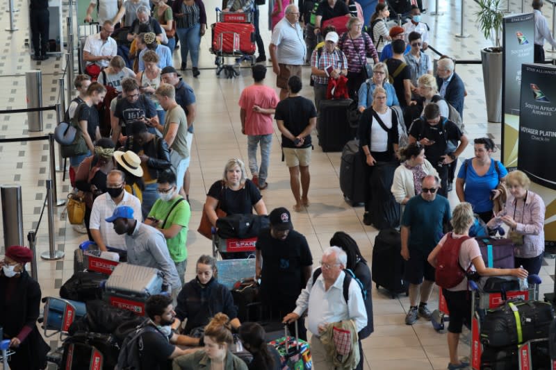 Passengers queue to check in for flights at Cape Town International Airport