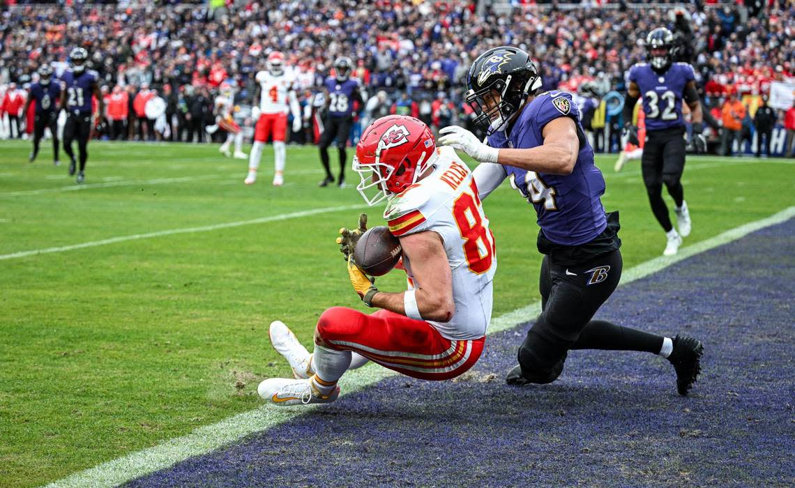 Kansas City Chiefs tight end Travis Kelce (87) comes down with a touchdown catch in front of Baltimore Ravens safety Kyle Hamilton (14) in the first quarter Sunday, Jan. 28, 2024, during the AFC Championship Game in Baltimore. Emily Curiel/ecuriel@kcstar.com