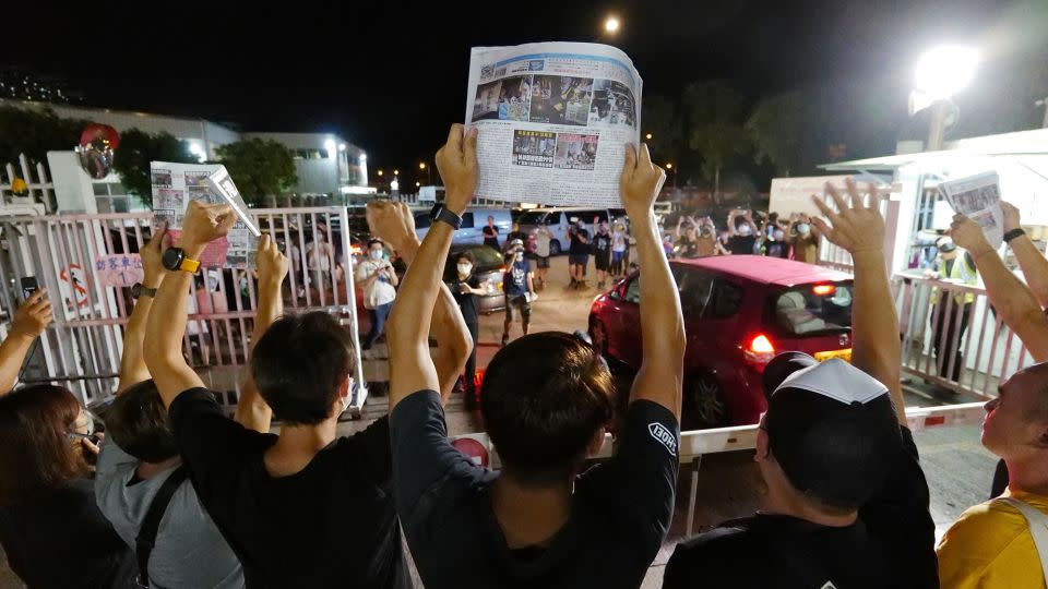 Apple Daily journalists held aloft copies of the newspaper's last edition as the paper closed after 26 years on June 24, 2021 - Daniel Suen/AFP/Getty Images