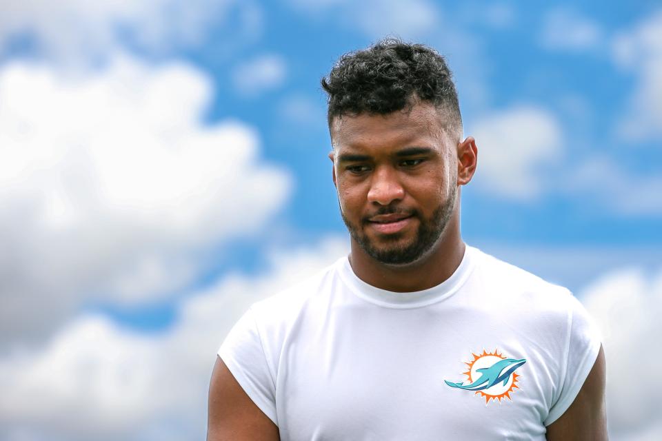 Miami Dolphins quarterback Tua Tagovailoa (1) walks on the field prior talking to reporters during minicamp at Baptist Health Training Complex.